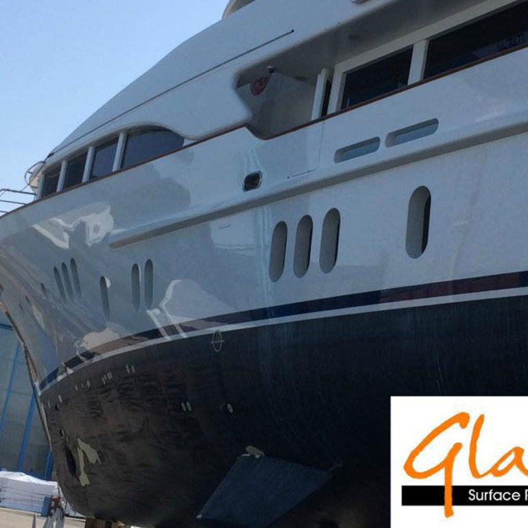 Reflective white yacht hull after glass coating surface restoration.