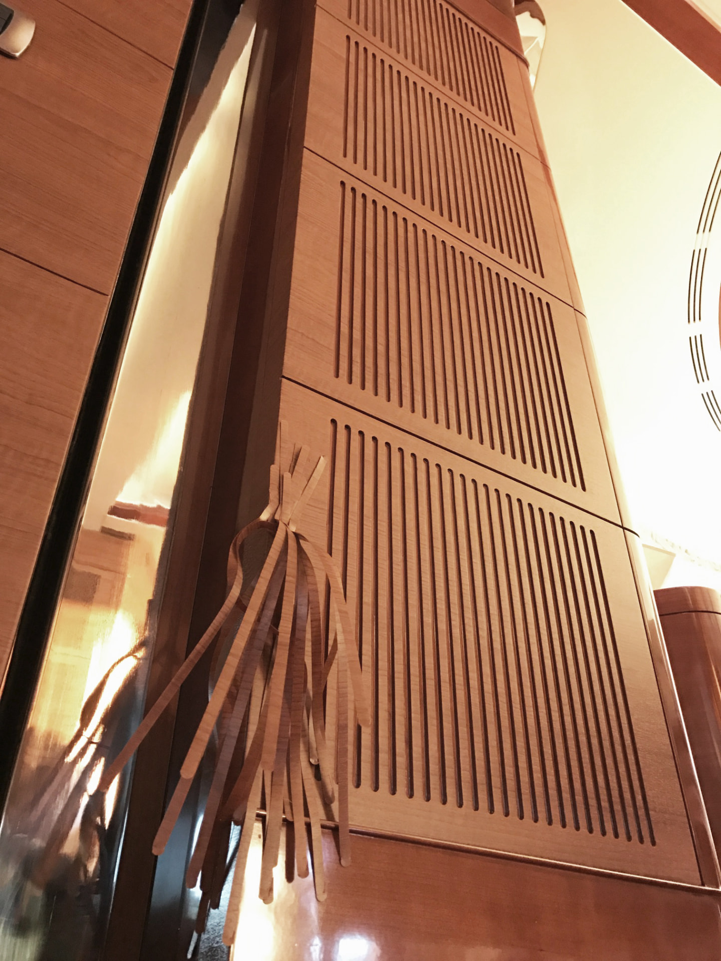 Wood-panelled ceiling and joinery inside a yacht interior.